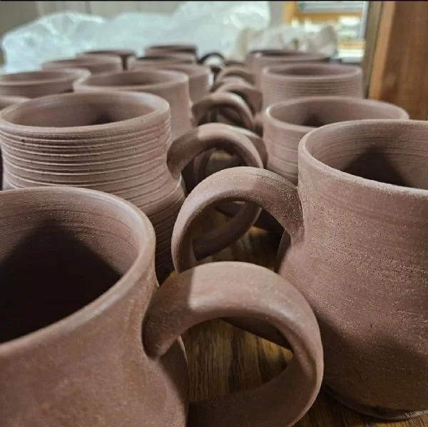 Image of a group of unglazed ceramic mugs
