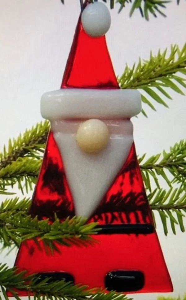 Fused glass santa ornament in a sprig of evergreen