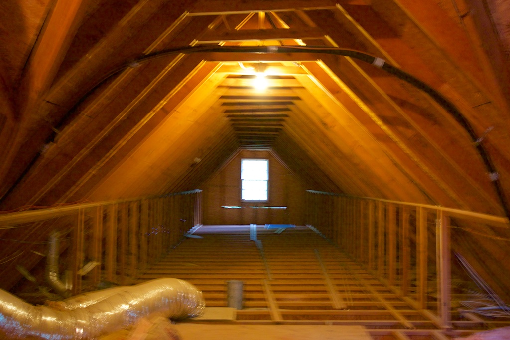 Here, I have walked into the attic and turned to the left, looking north into the area above the 4-car garage. At the end is that window that will be a sliding glass door leading out to the deck. The area from about the end of those vents on the left, to the window at the end of the garage, will be my new studio. On the left, there will be the 12' x 6' dormer. On the right, there will be 3 skylights in the angled roof. The kitchen and bath will be on the right, across from the vents. I'm taking this pic from what will be the living area, and there will be french doors between the living area and the studio.