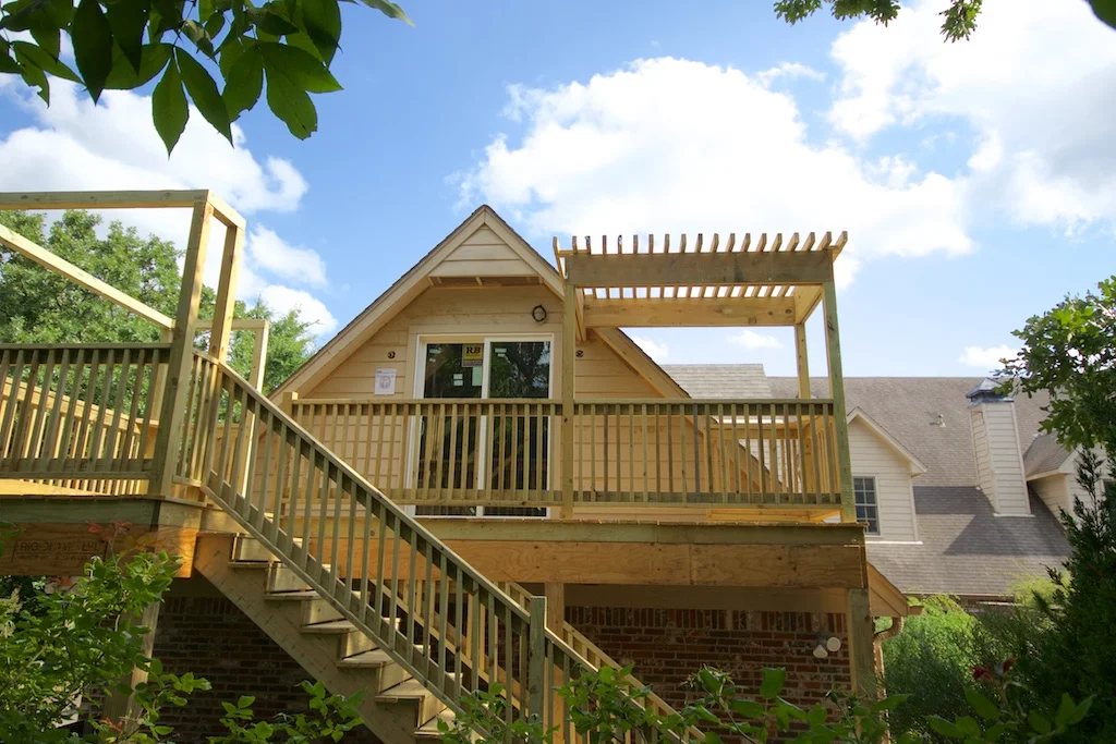 We have jazzed up the deck with a nice lattice of 2' x 4's on the west side. On the east side, we extended the posts up and connected them, giving me a nice place for hanging flower baskets, chimes, and other pretties.