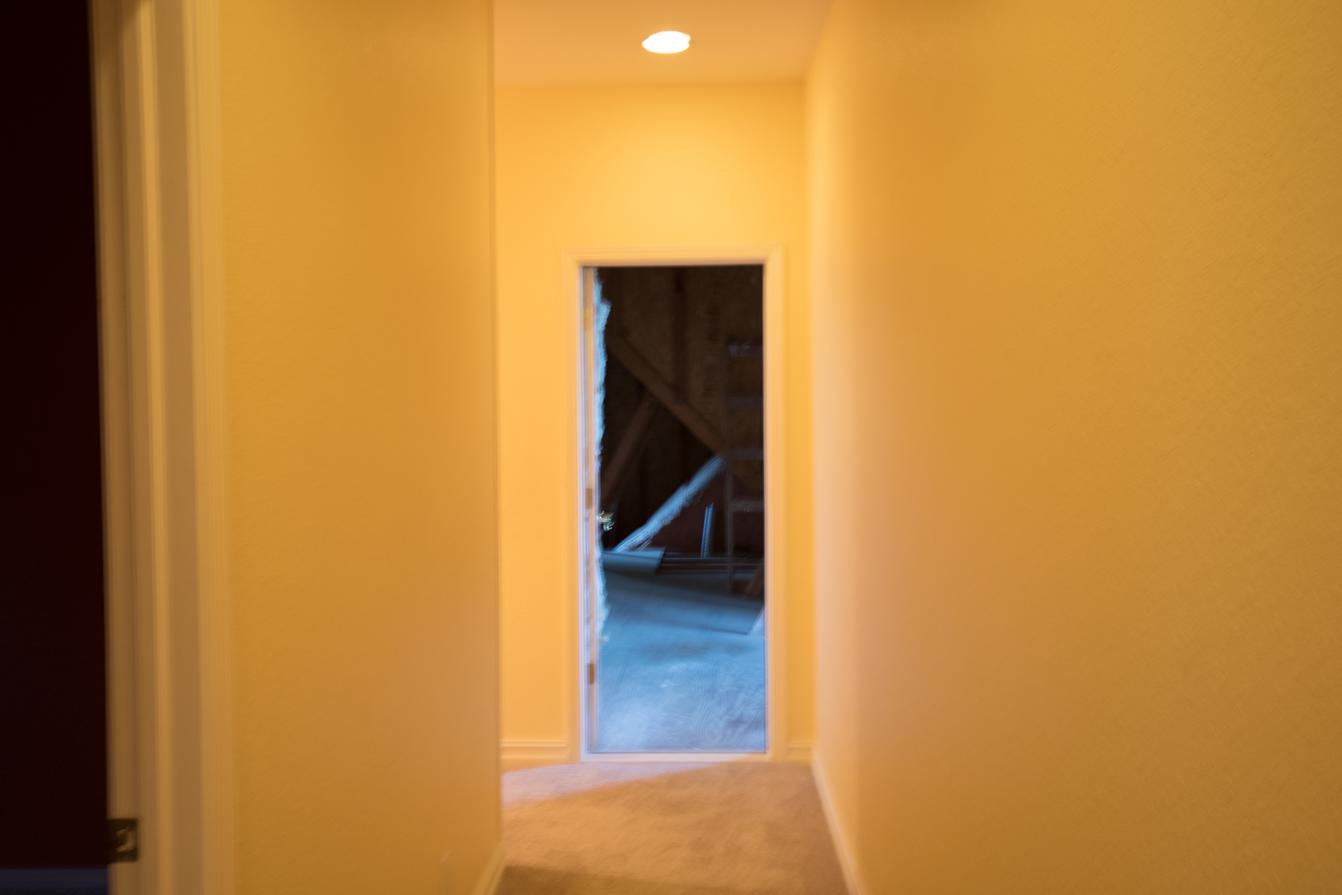  Before construction: Attic door at end of hallway. 
