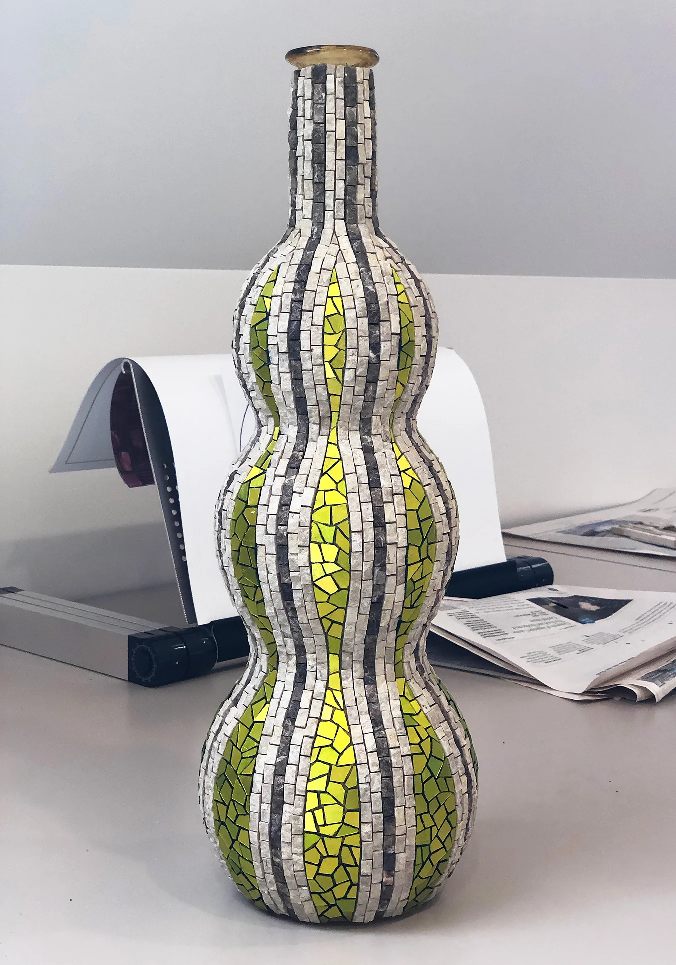 Currently untitled. 18.5” x 6” | 47cm x 15cm. Marble, mosaic gold, on glass bottle.