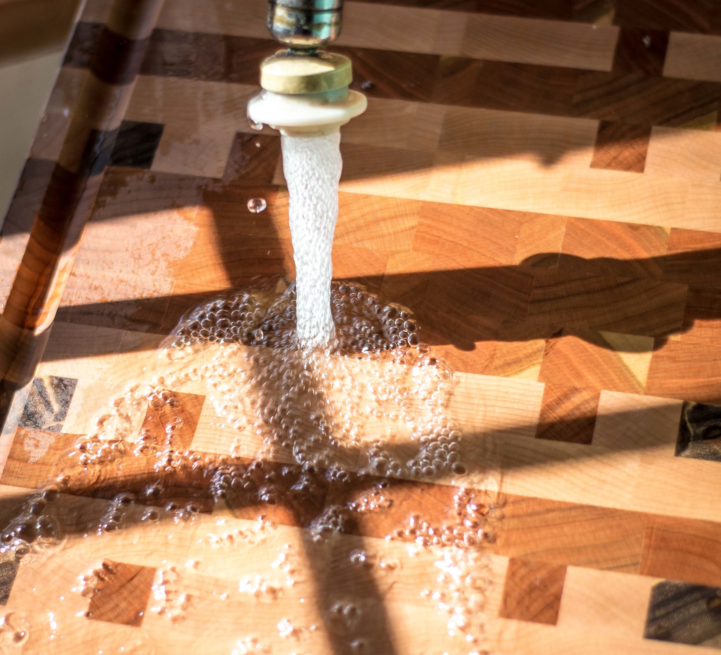Cutting board being washed in sink