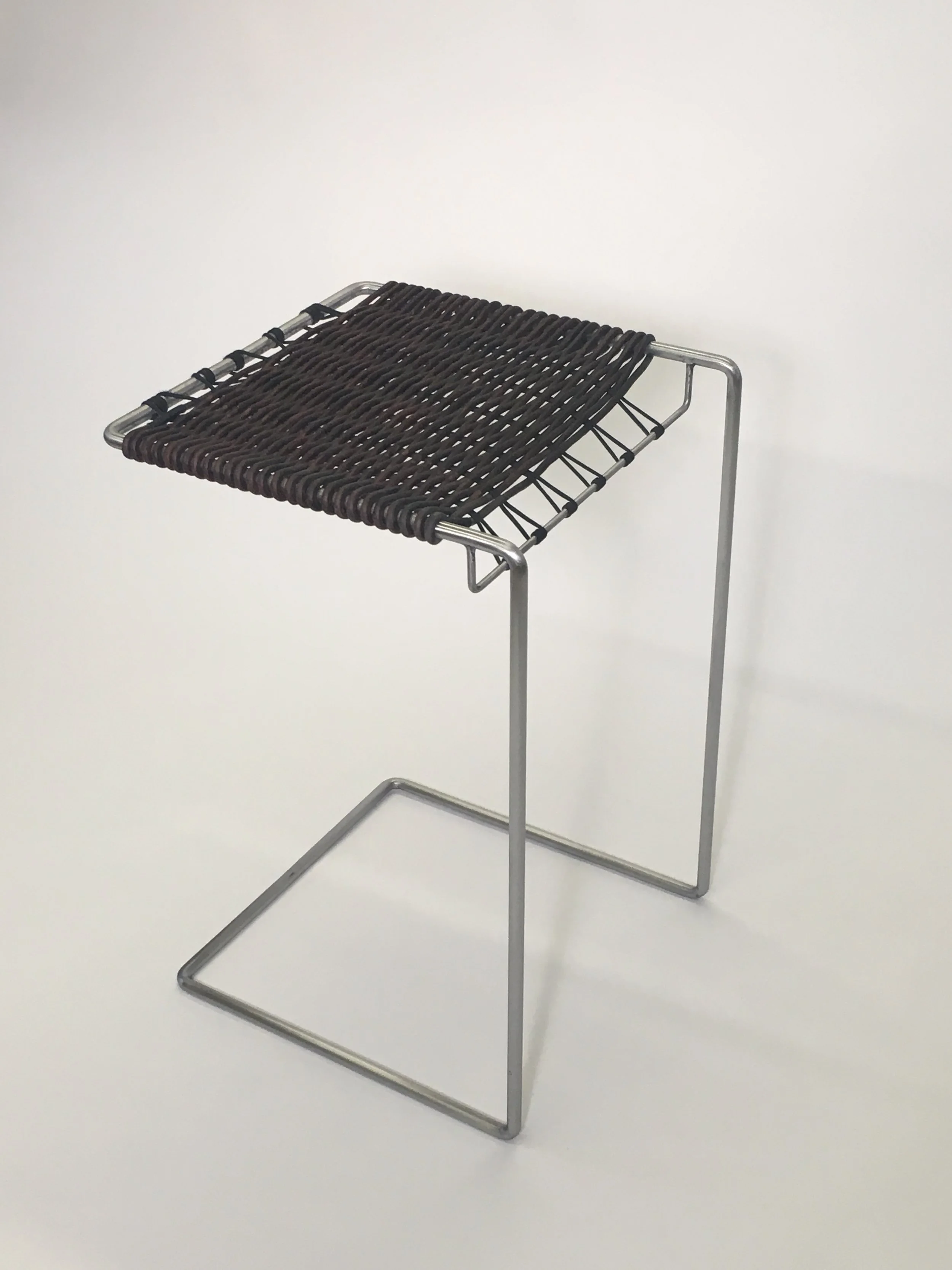 Bent steel and woven leather table 