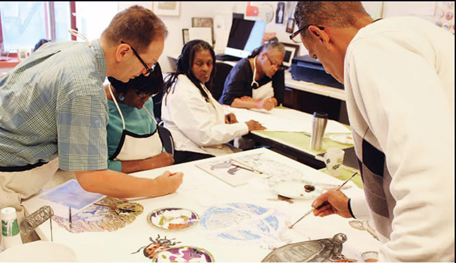 Jerald Frampton assists a group of ElderCare clients at Odyssey House's 121st Street art studio.