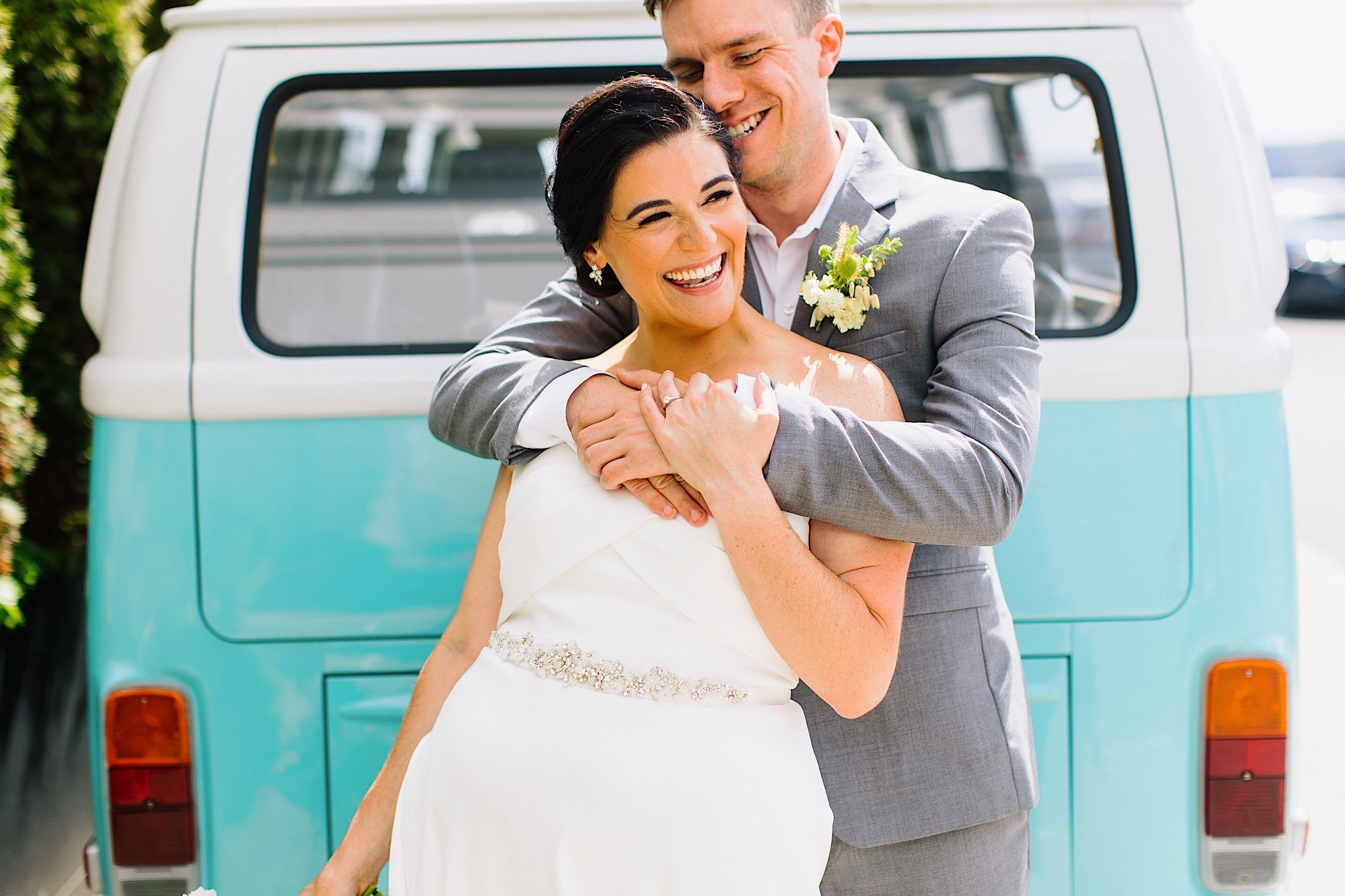 053-ZacWolfPhotography-20220807-Blog_Bride-and-Groom-hugging-in-front-of-vintage-VW-bus.jpg