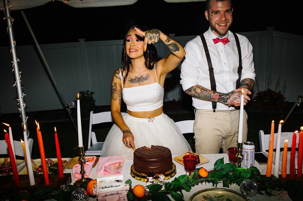 059-ZacWolfPhotography-20220813-Blog_Bride-and-Groom-cutting-cake-at-reception.jpg