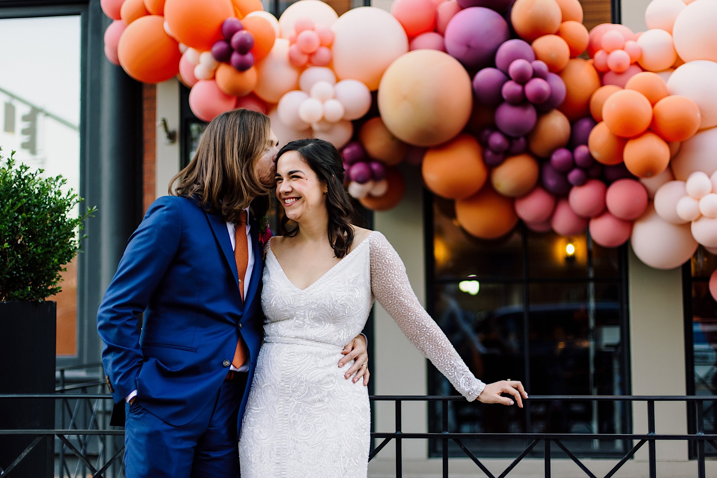 101-ZacWolfPhotography-20221015-Blog_Bride-and-Groom-in-front-of-Balloon-arch-at-wedding.jpg