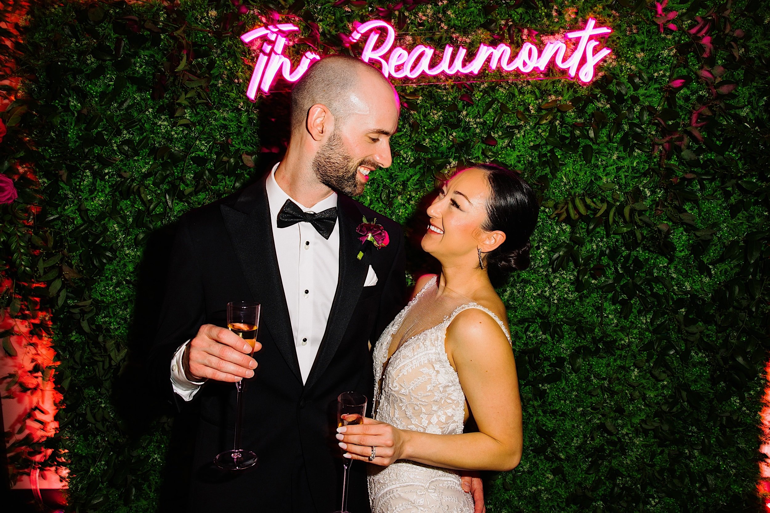 112-ZacWolfPhotography-20221104-Blog_Bride-and-Groom-in-front-of-neon-sign.jpg