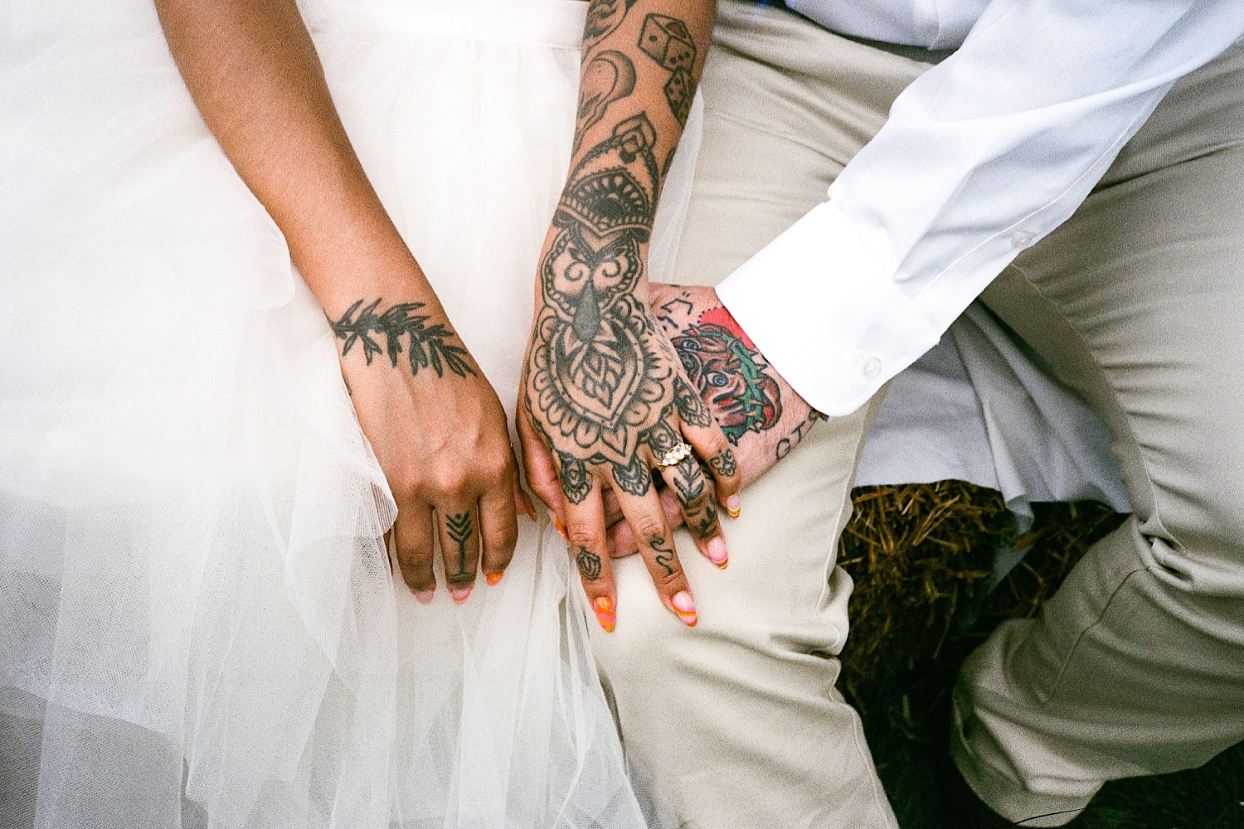 Scan05_heavily tattooed Bride and Groom holding hands.jpg