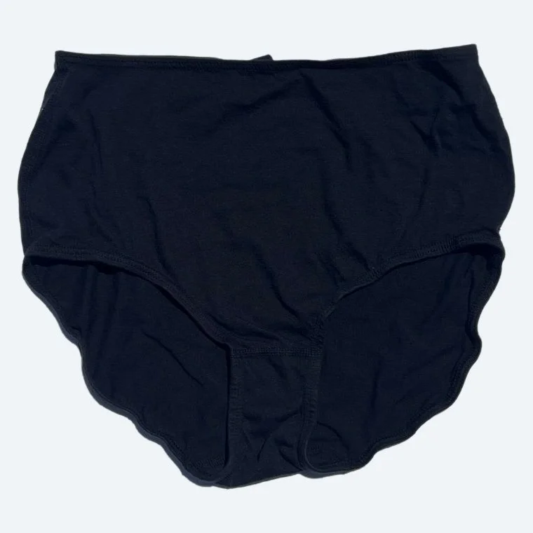 Flat lay of Pansy short xtra high rise underwear in black on a pale blue-gray background.