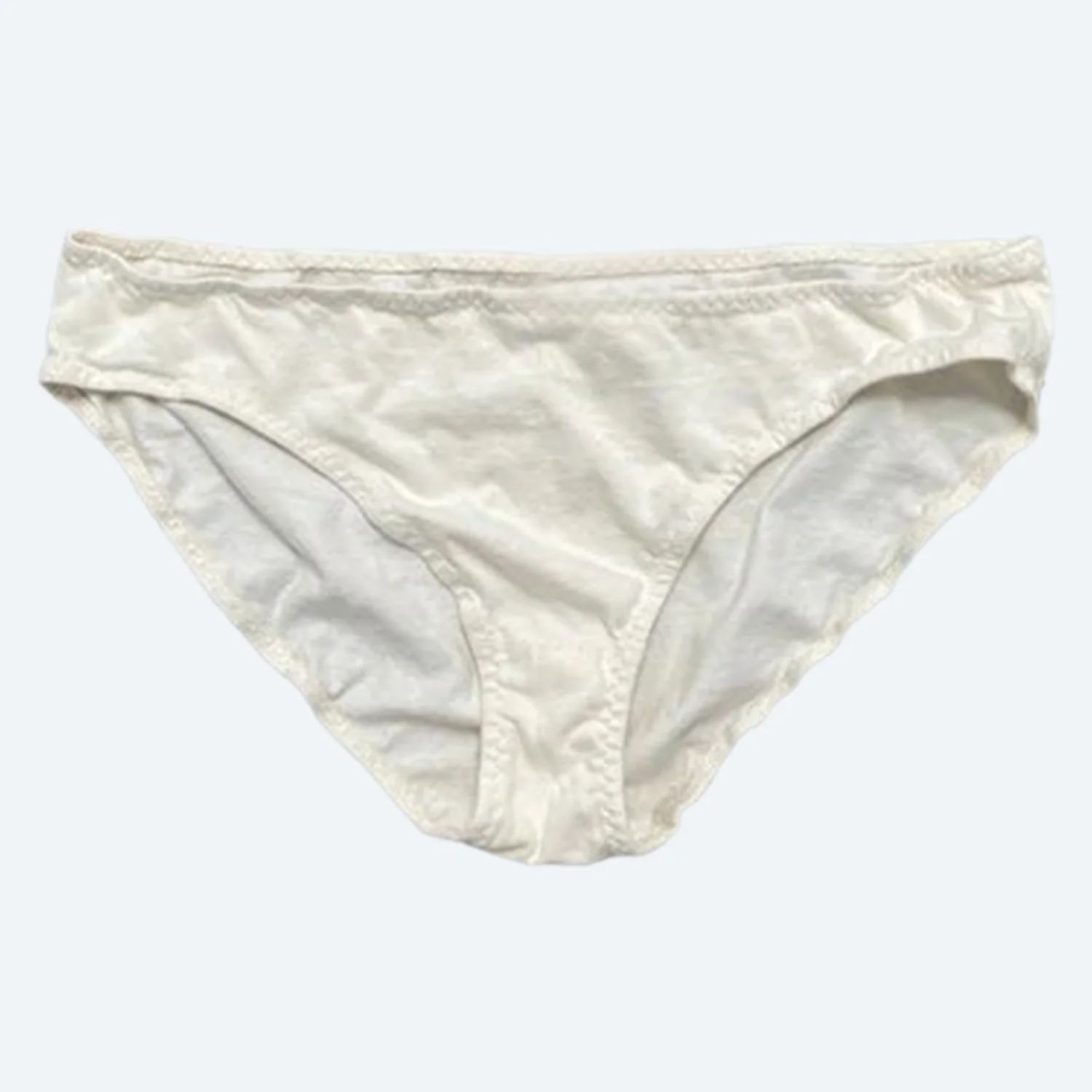 Front view of Pansy organic cotton Low Rise underwear in Natural, laid flat to show the low waistband and curved leg openings.