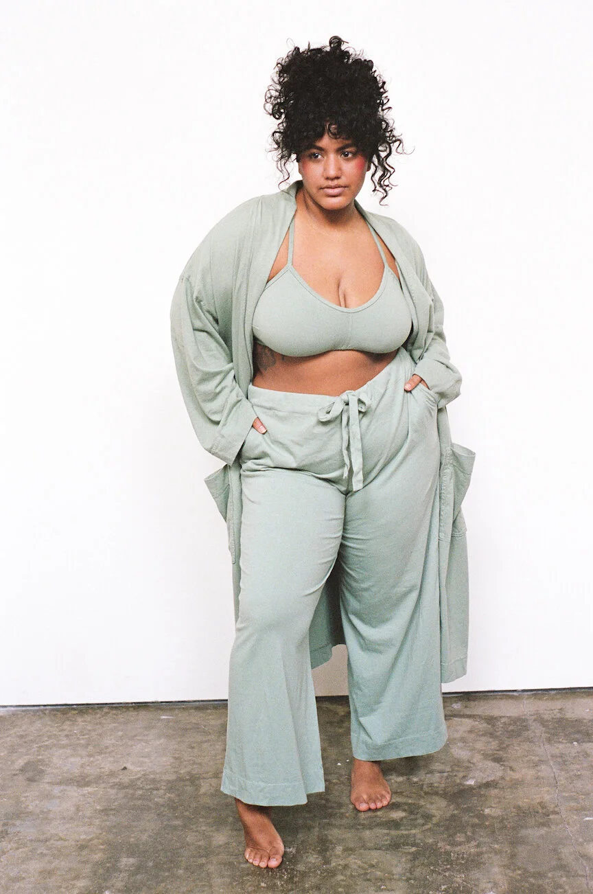 A model wears a Pansy bra, robe, and drawstring pants, all in the color Mermaid.