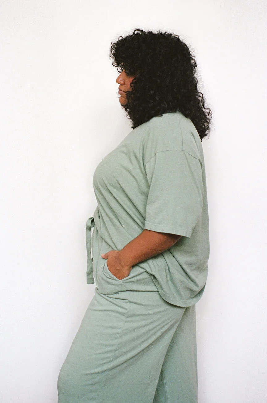 Side view of a model wearing a Pansy t-shirt and drawstring pants, both in the color Mermaid.