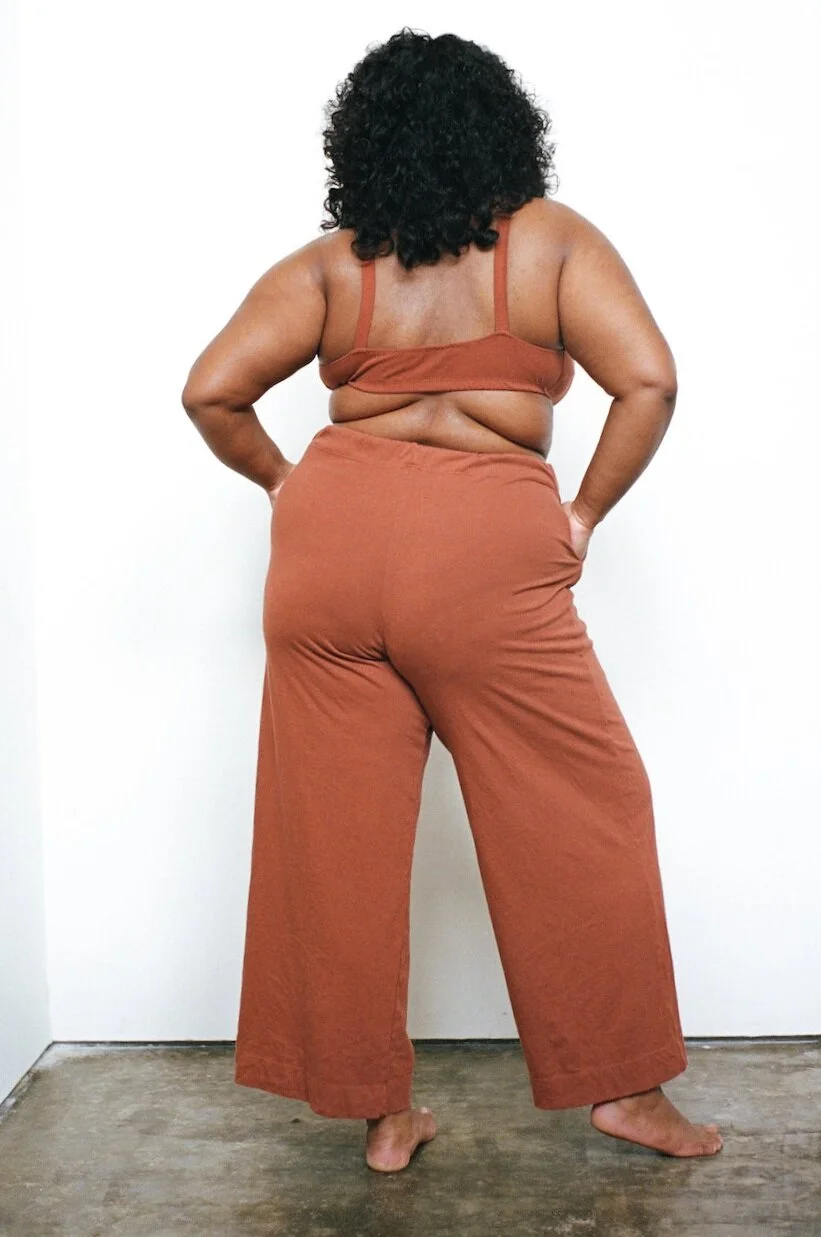 Rear view of Pansy Drawstring Pants in Rust.