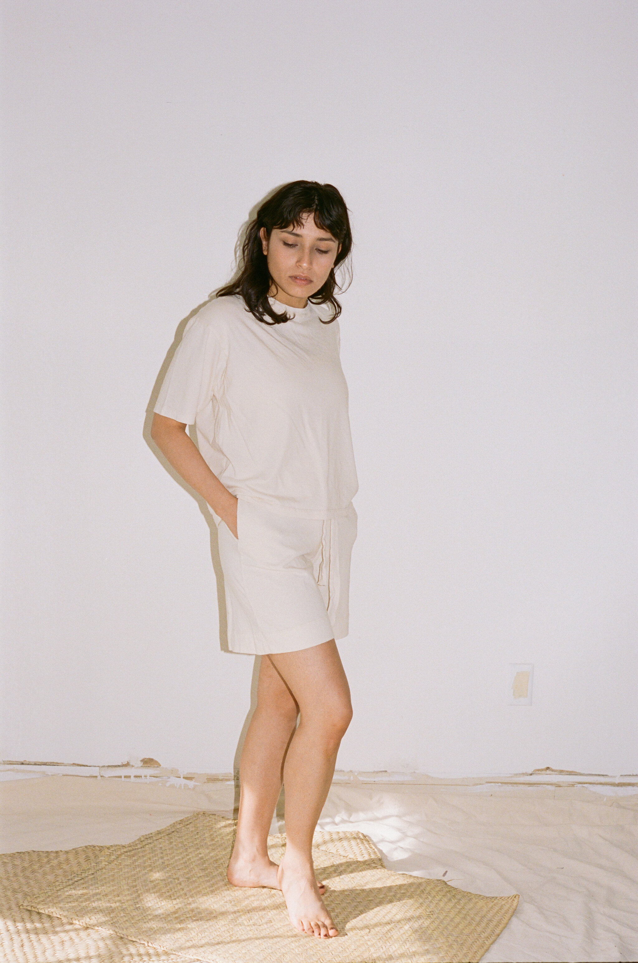 A model wears Pansy Gym Shorts in natural with a matching Pansy T-Shirt.