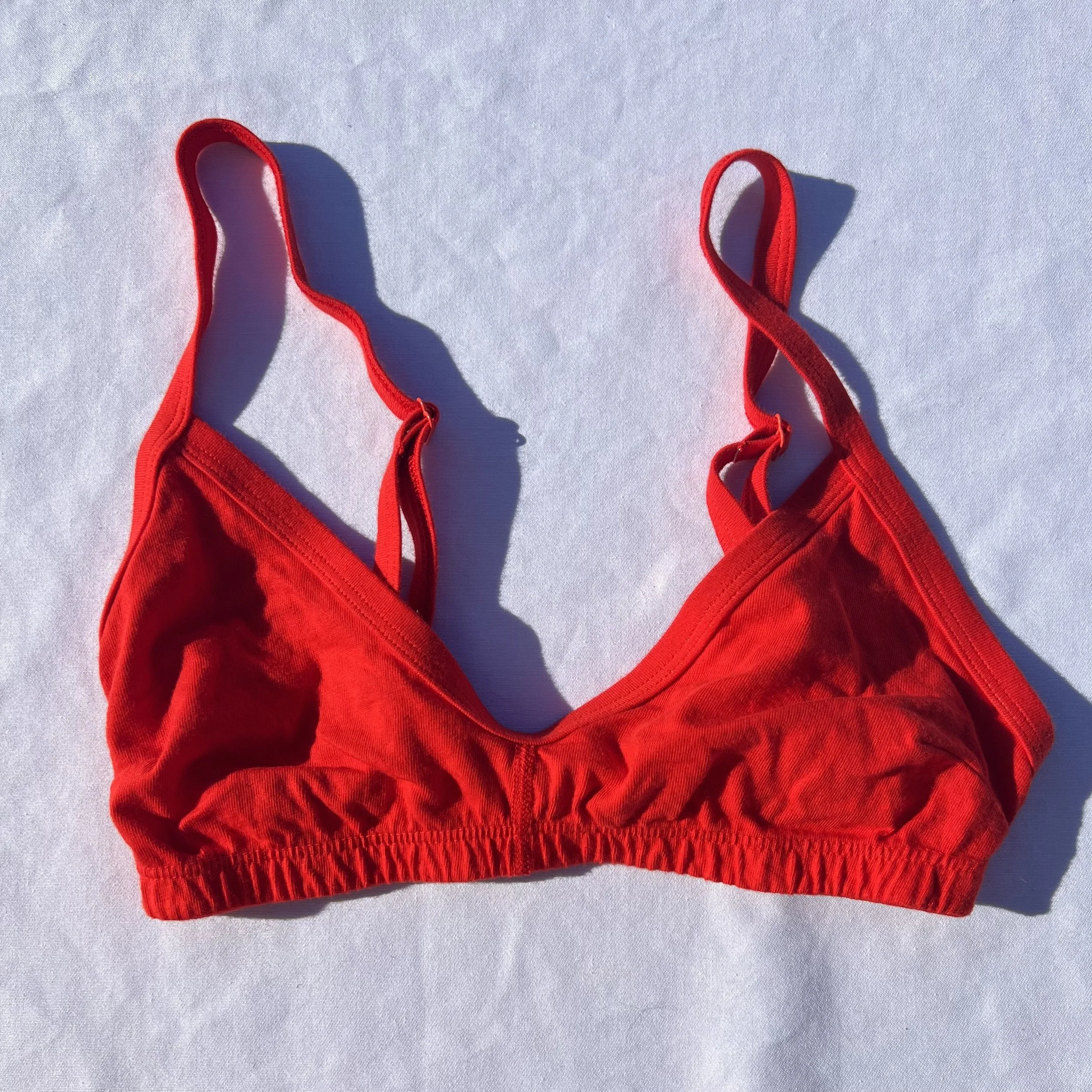 Flat product photograph of Pansy's organic cotton Smile Bra in the color Red.