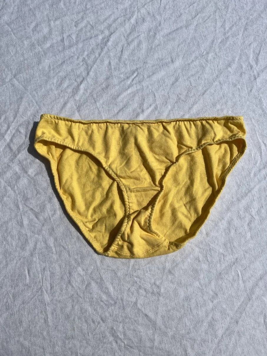 A flat photo of Pansy organic cotton low-rise underwear in butter yellow.