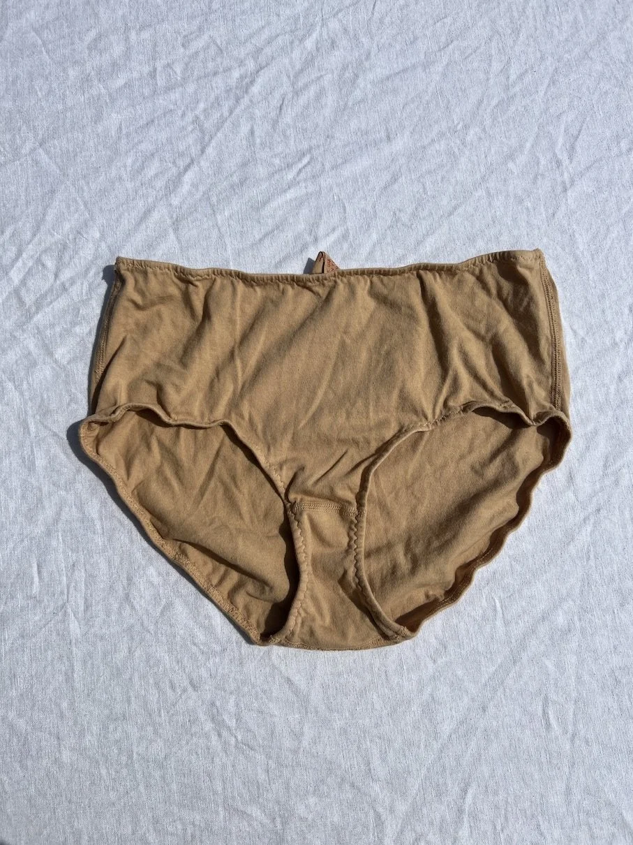 A pair of Pansy organic cotton high-rise underwear in the color sand.