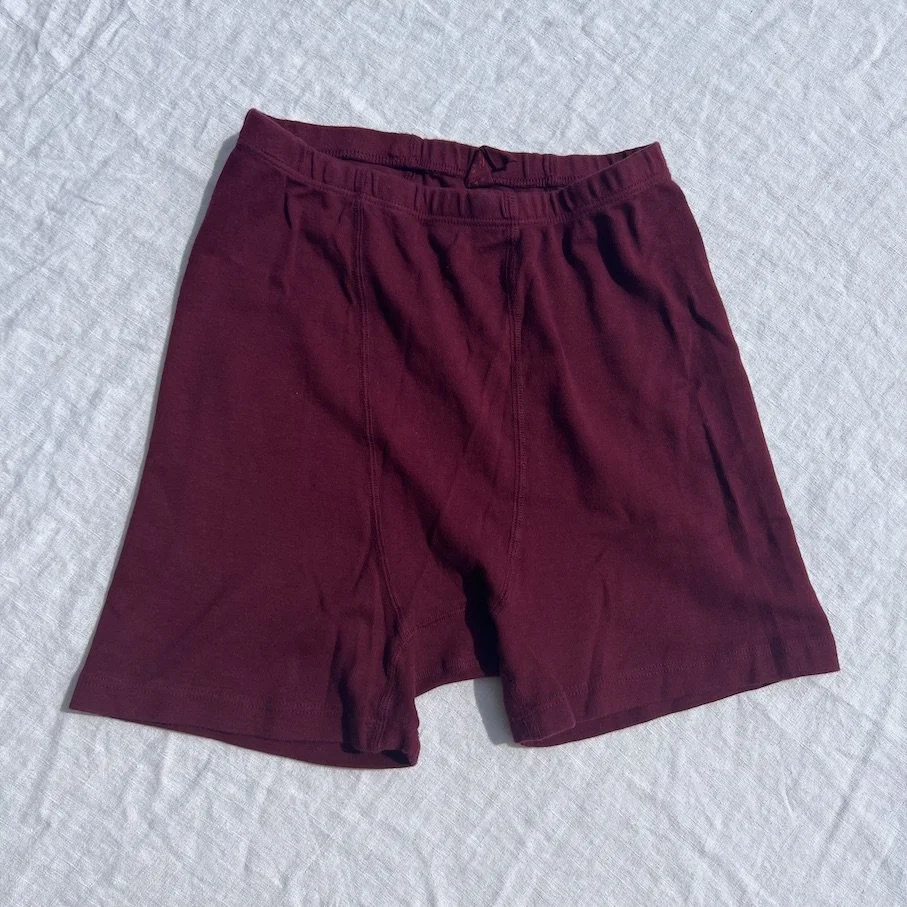 Flat front view of Pansy Stretch Shorts in the color Wine.