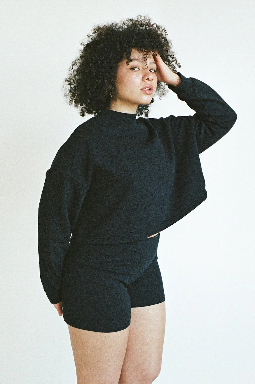 Side view of Pansy Fleece Top in black.