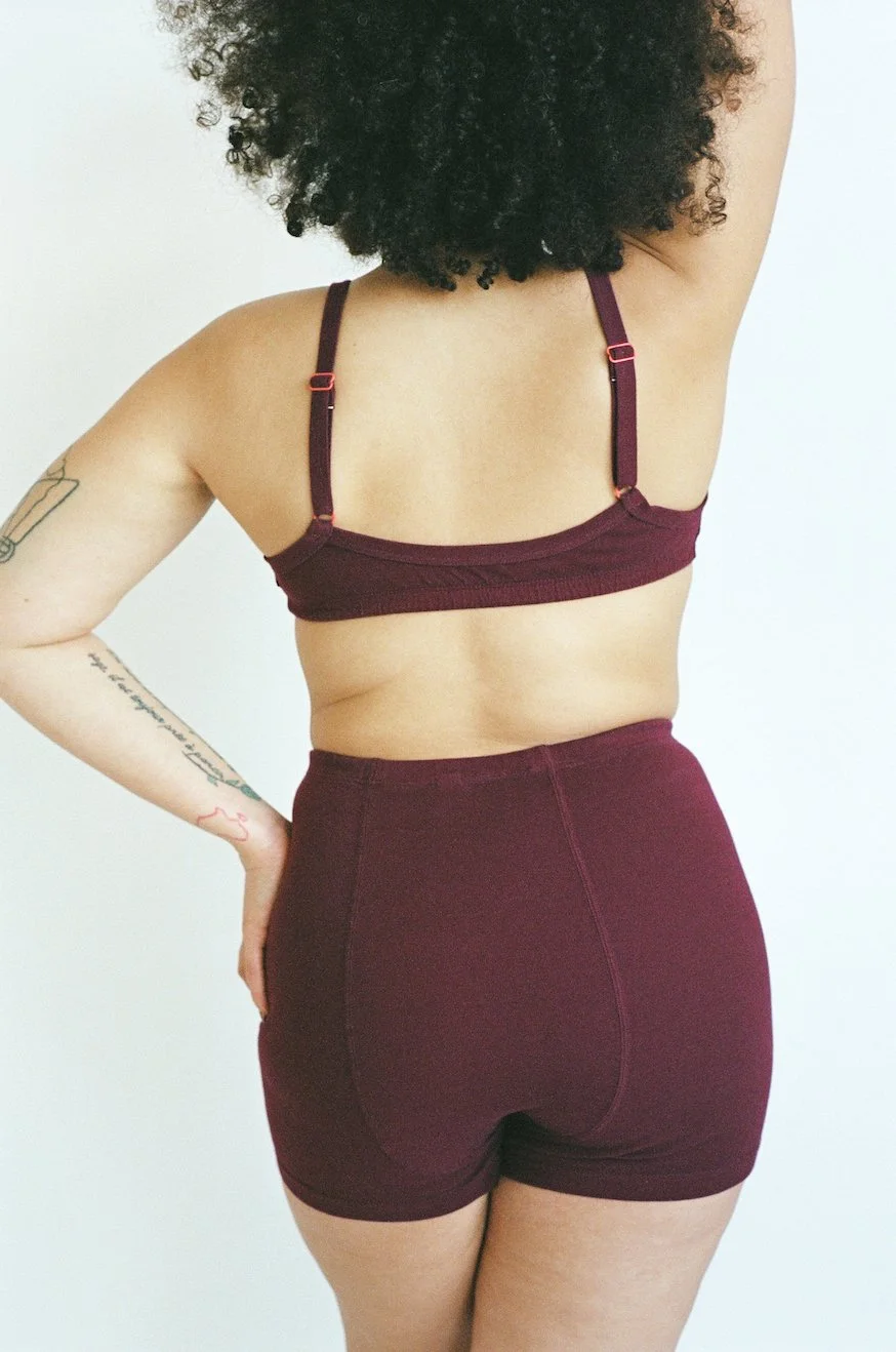 Rear view of Pansy organic cotton stretch shorts in Wine.