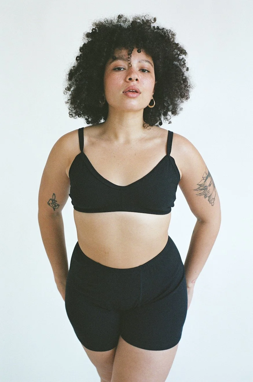 A model looks confident in black Pansy Stretch Shorts.