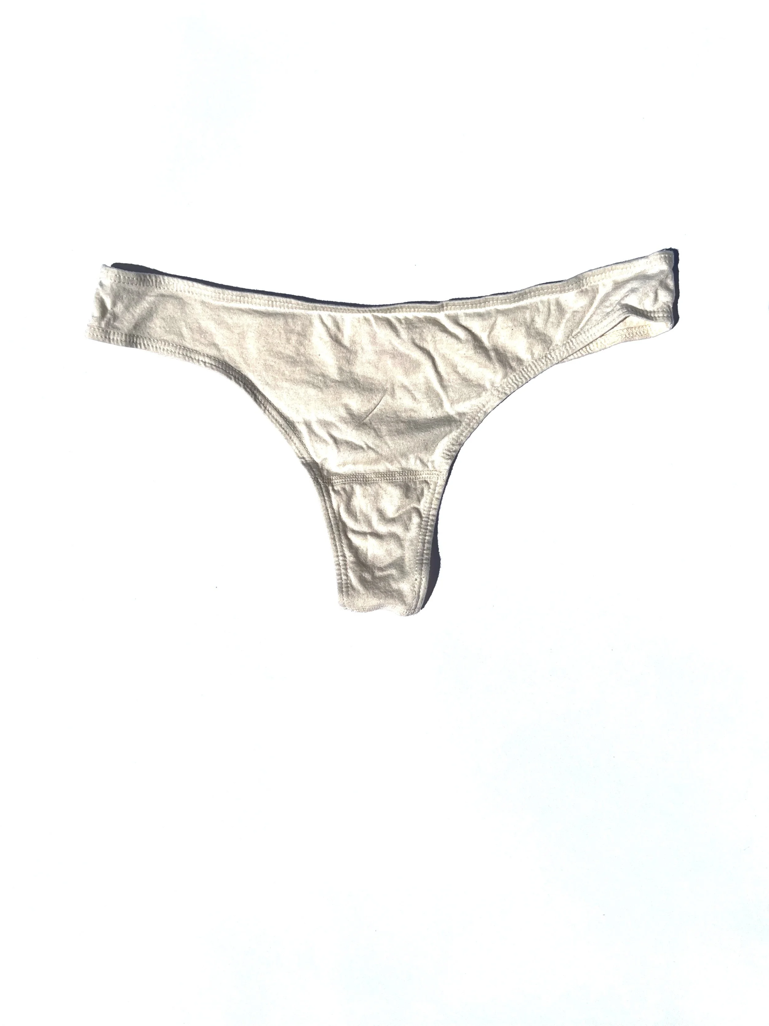 Flat view of the Pansy organic cotton thong in Natural