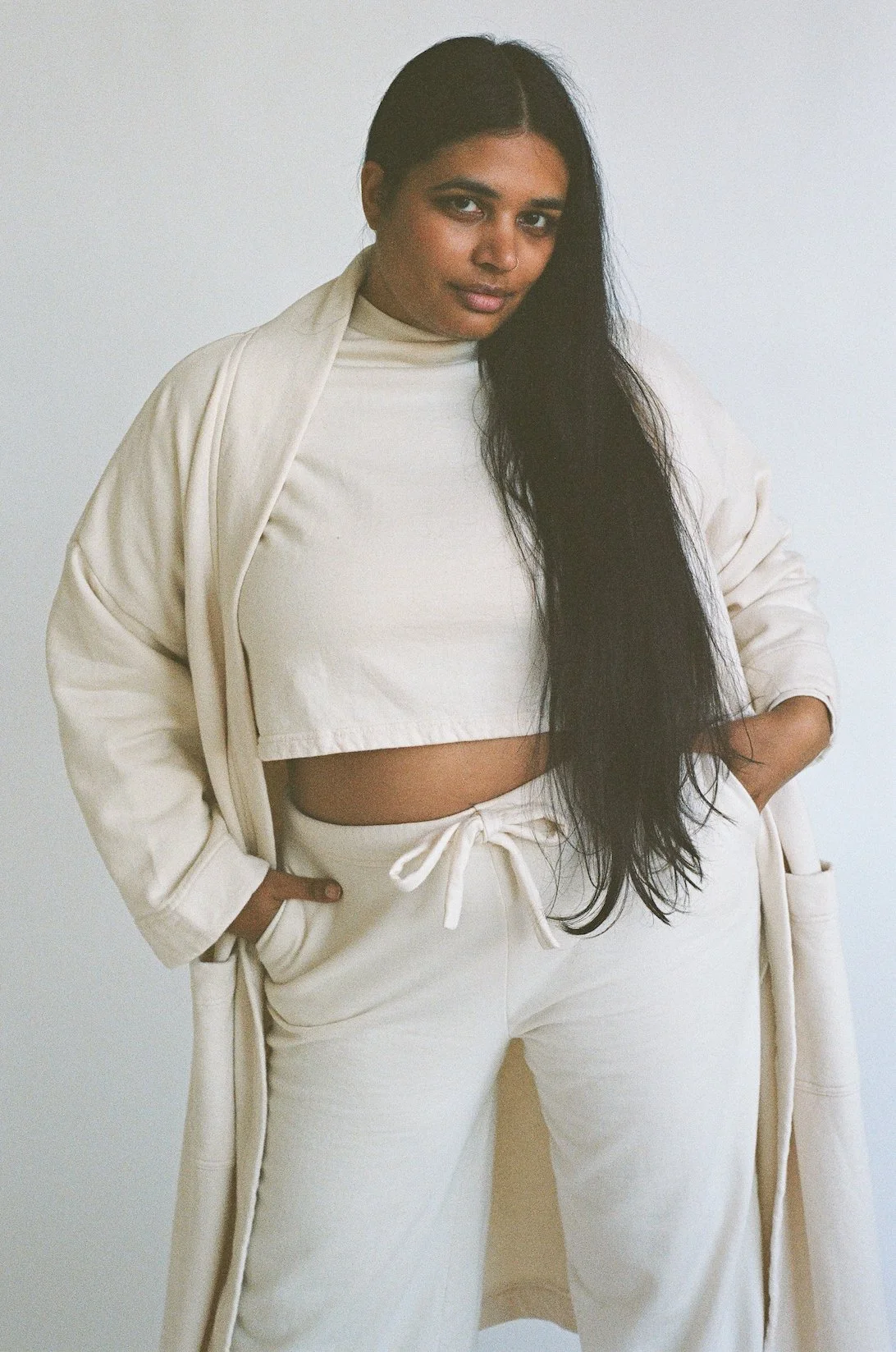 Close-up front view of Pansy organic cotton Fleece Pants in Natural worn with matching Robe and T-shirt.