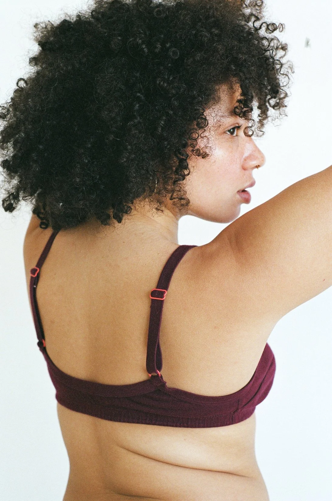 Close-up 3/4 rear view of the Pansy Smile Bra in Wine showing bra strap adjustment hardware.