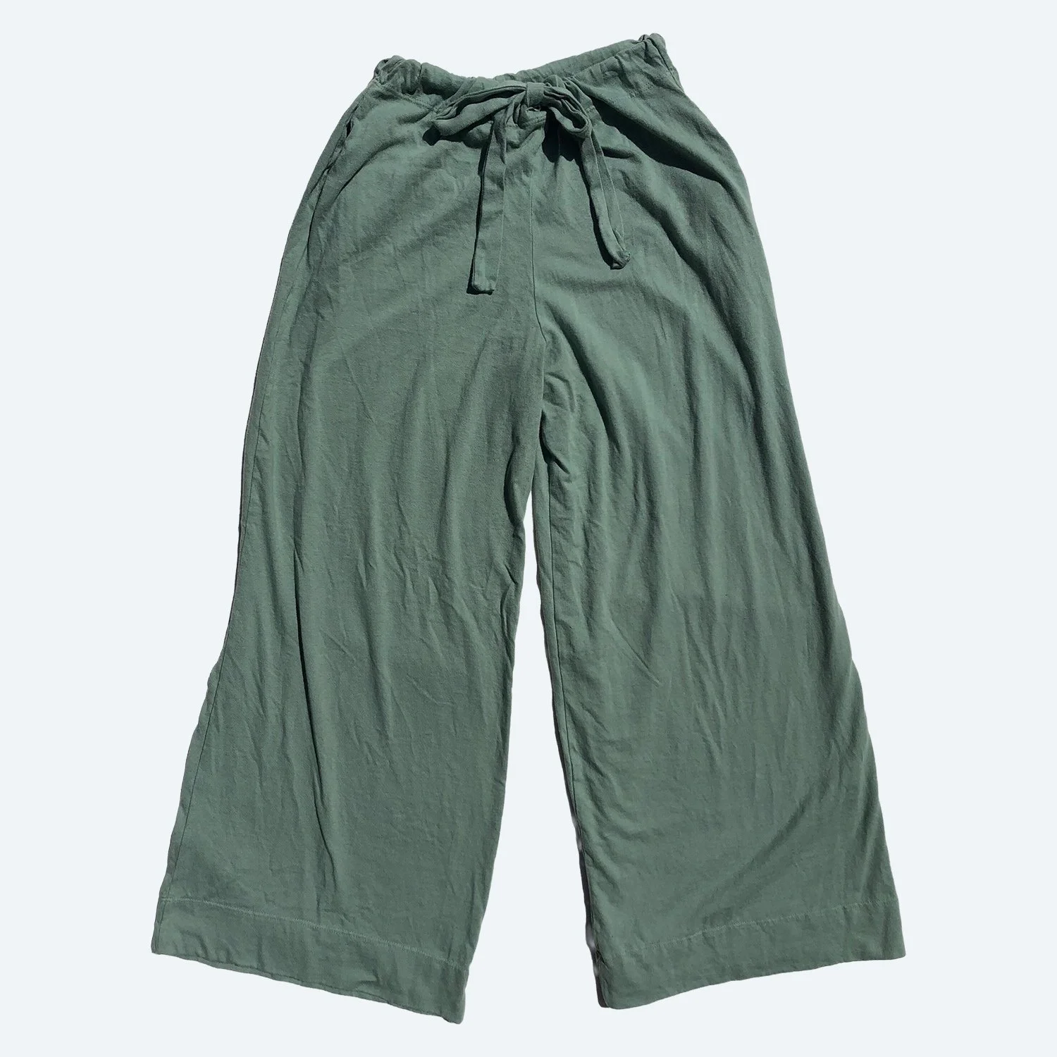 Front view of Pansy organic cotton Drawstring Pants in Mermaid green, laid flat with a tied waistband and wide legs.