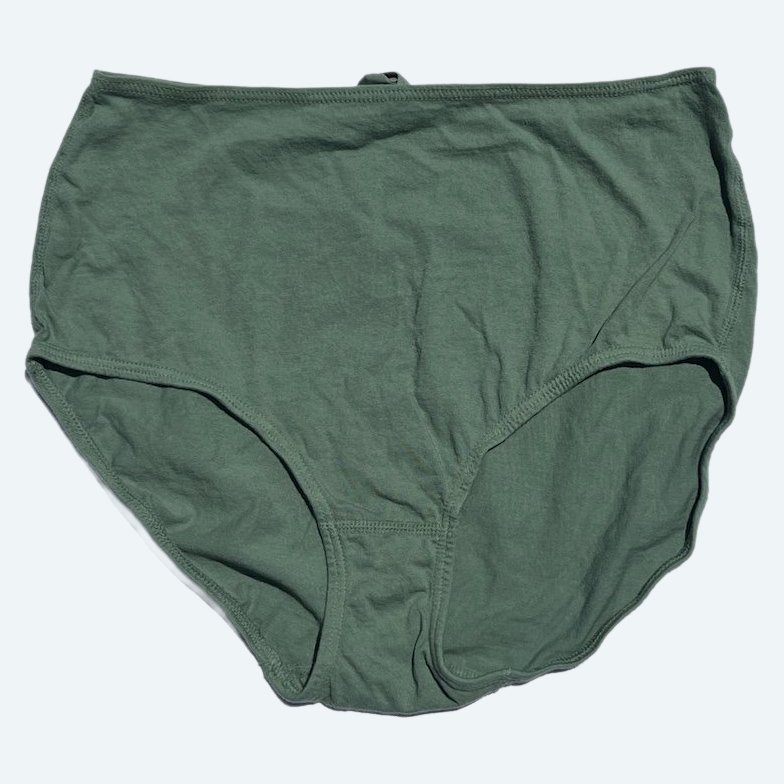 Flat lay of Pansy short xtra high rise underwear in mermaid green on a pale blue-gray background.