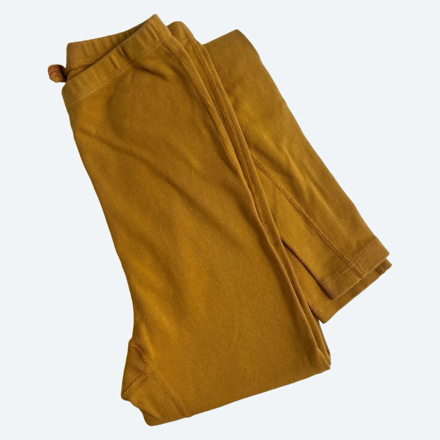Pansy organic cotton Leggings in Gold, folded to show the waistband and ribbed fabric.