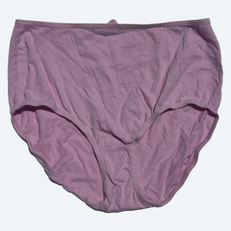 Flat lay of Pansy short xtra high rise underwear in blossom pink on a pale blue-gray background.