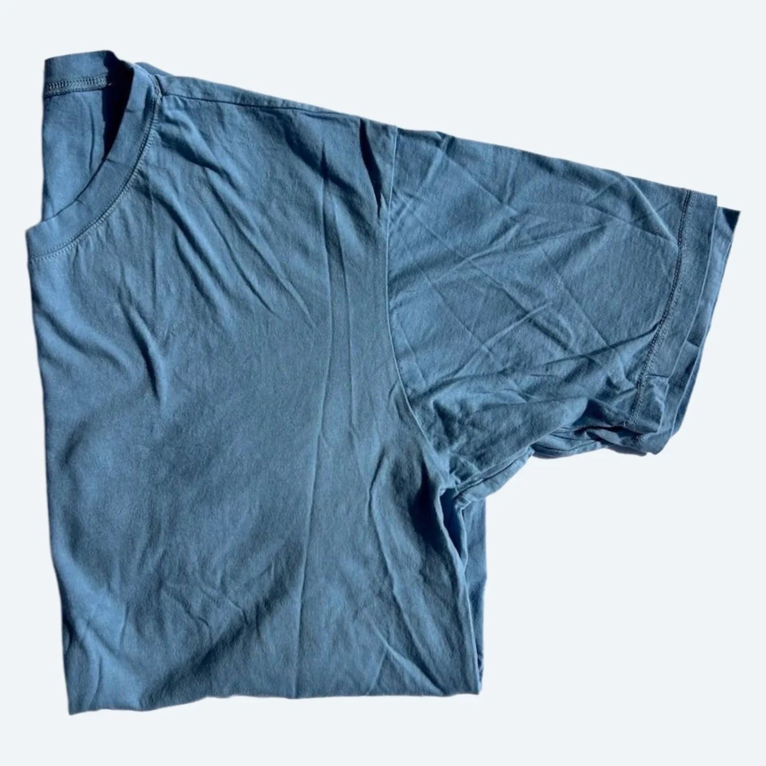 Pansy organic cotton T-shirt in Sky blue, folded to show the crew neckline, short sleeve and fabric texture.