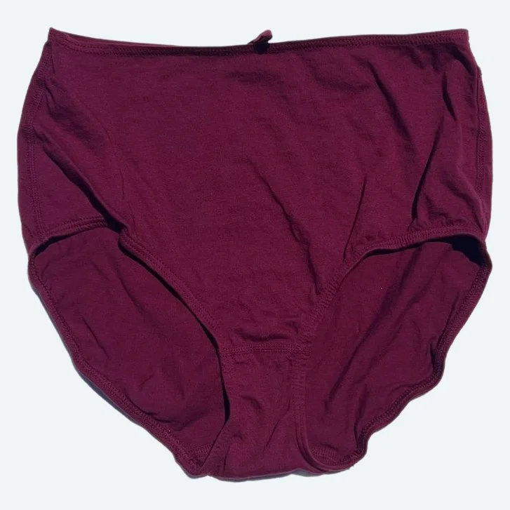 Flat lay of Pansy short xtra high rise underwear in wine on a pale blue-gray background.