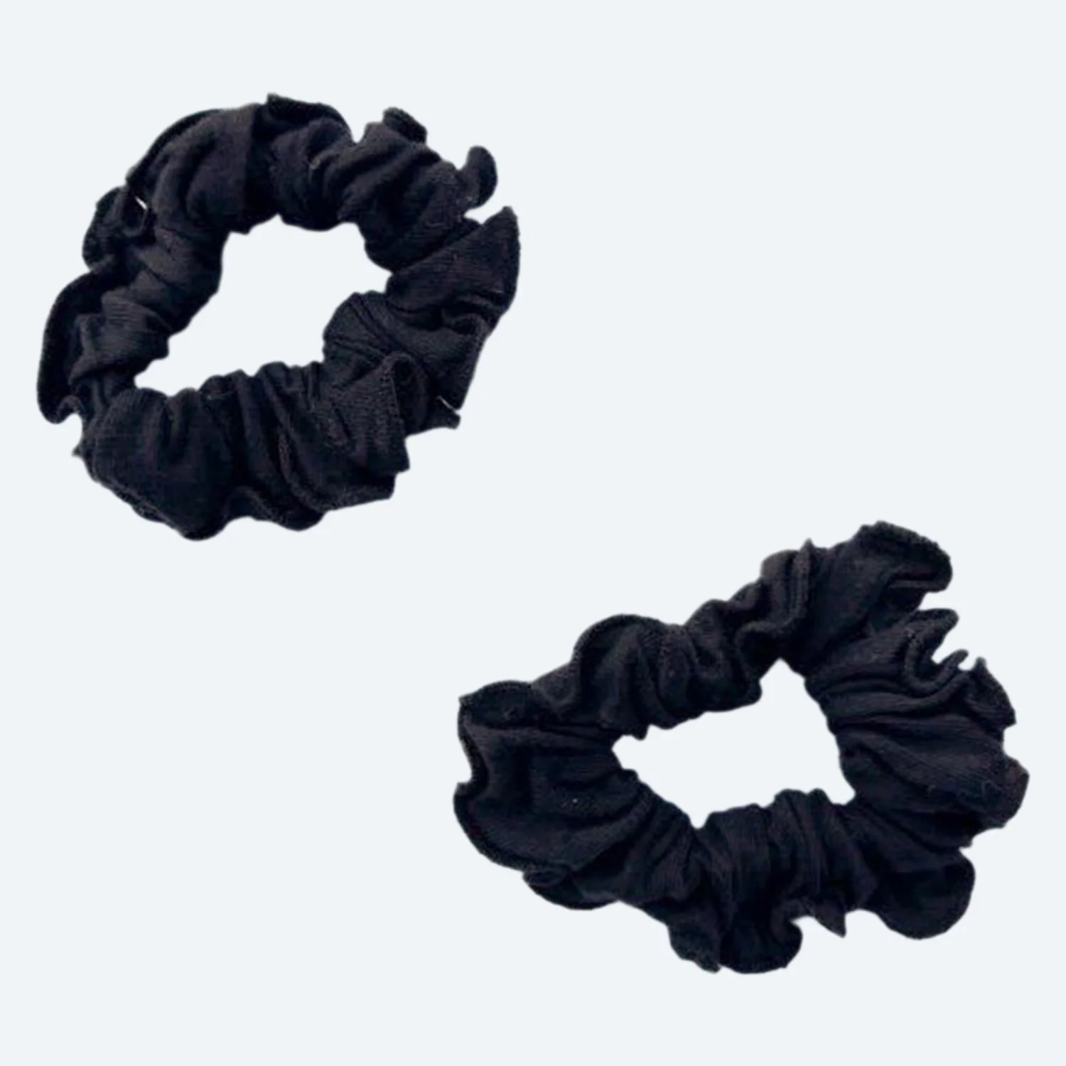 Two Pansy organic cotton scrunchies in Black, laid flat.