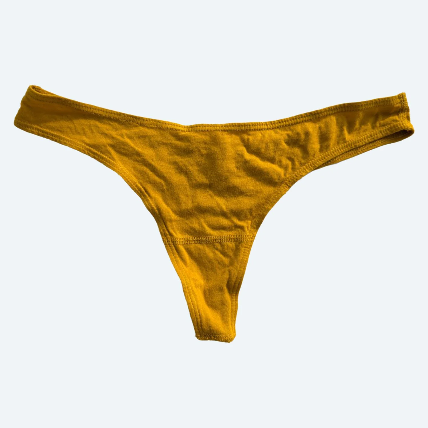 Front flat view of the Pansy organic cotton thong in Gold