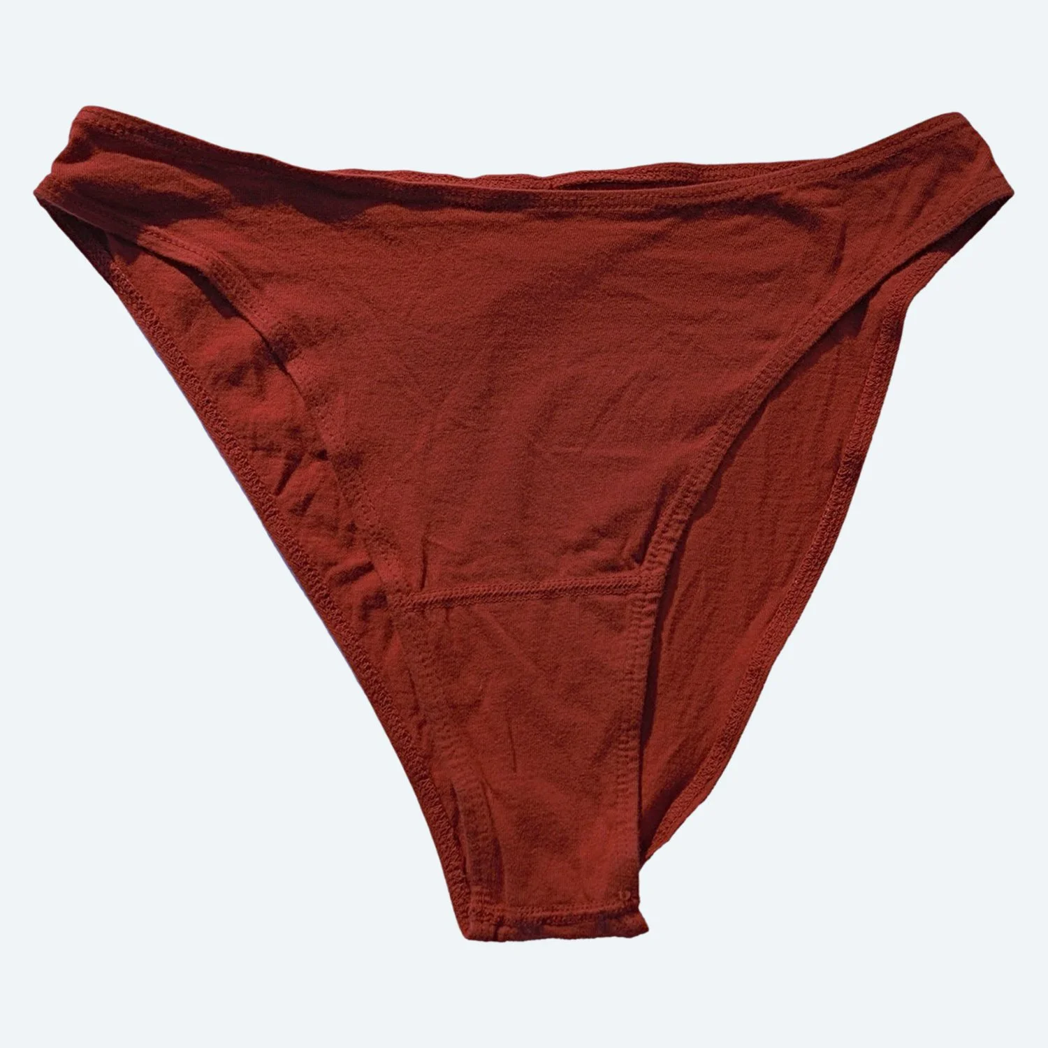 Front view of Pansy organic cotton French Cut underwear in Rust, laid flat to show the high-cut leg openings.