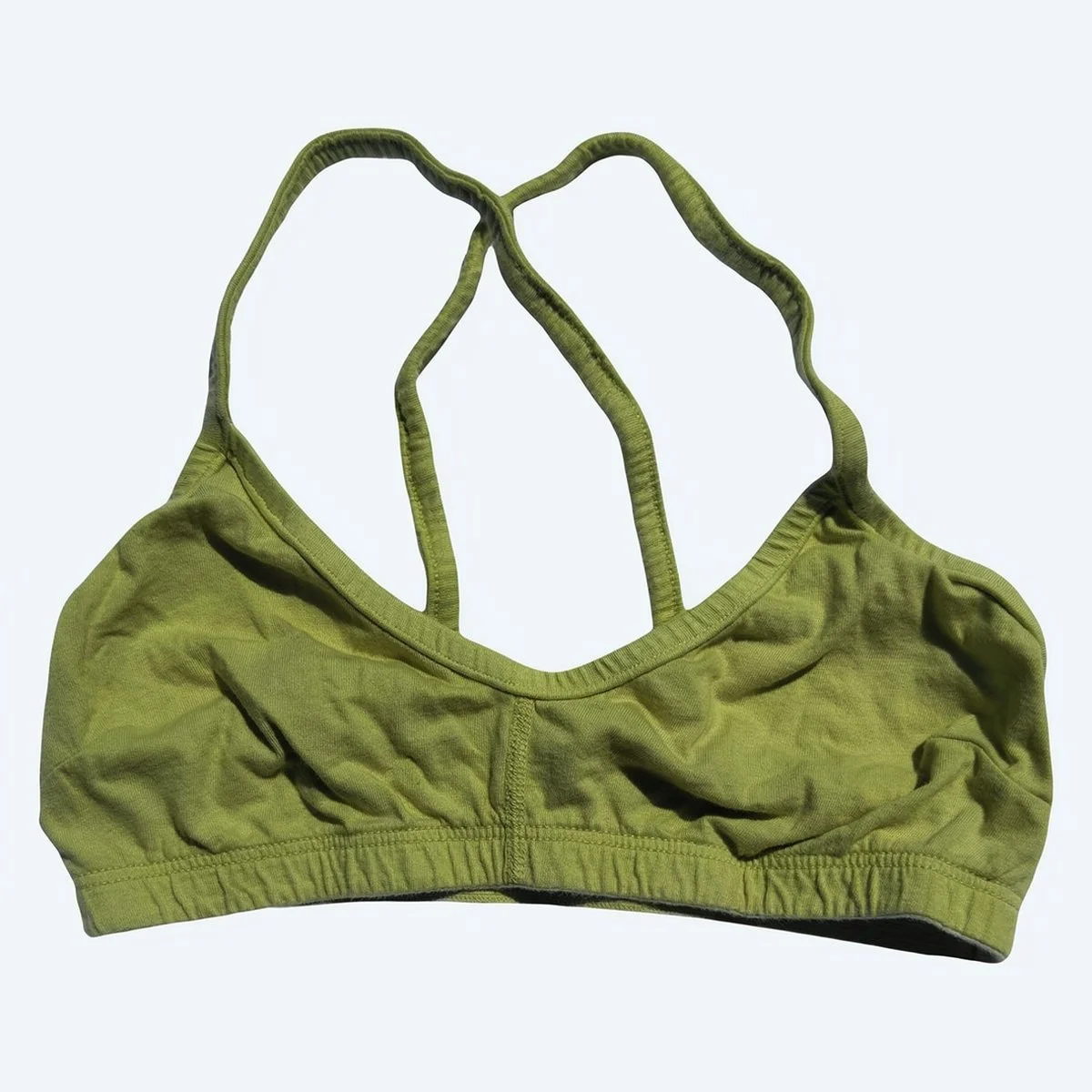 Pansy Cross Bra in Moss green, laid flat from the front with crossed straps and a gathered underband.