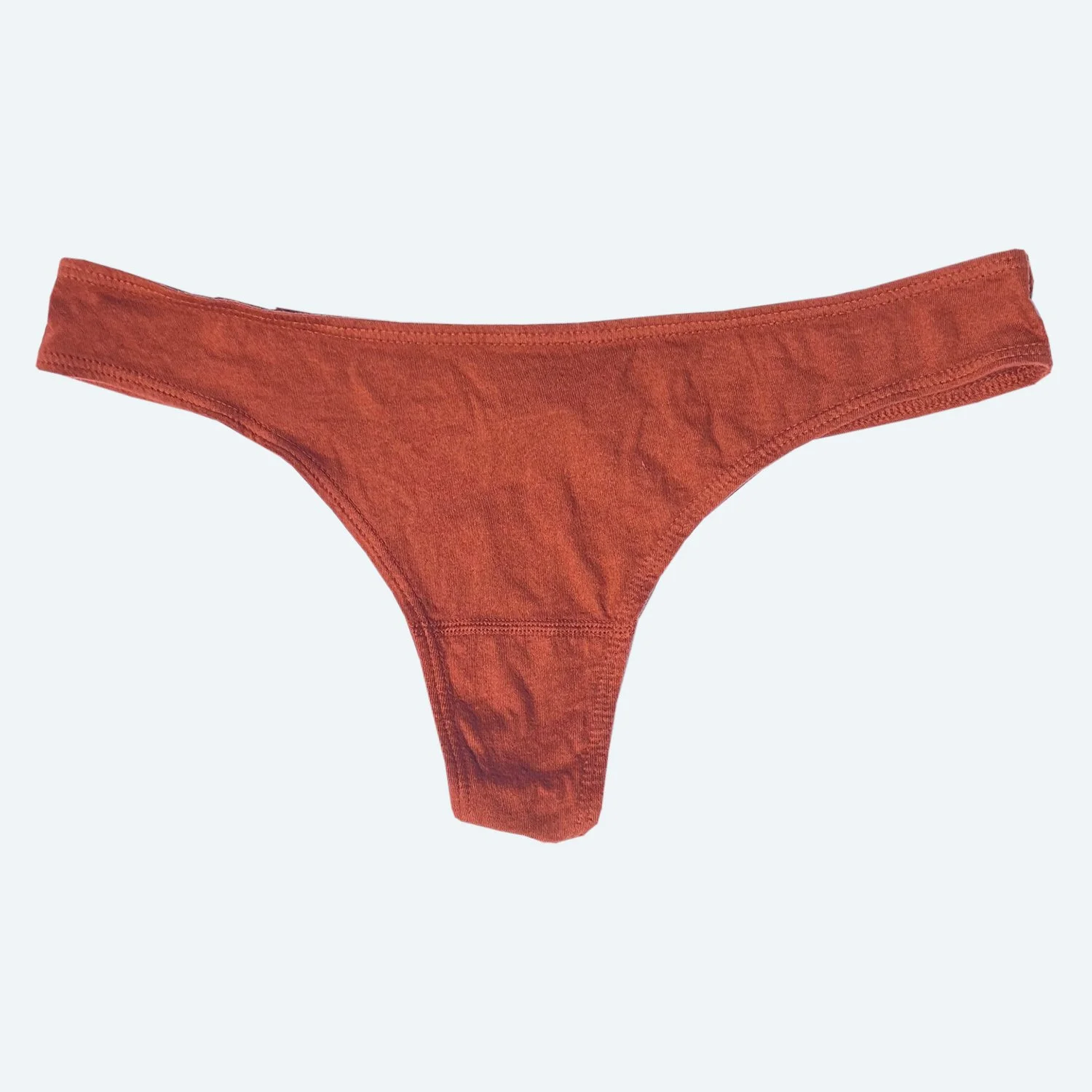 Front flat view of the Pansy organic cotton thong in Rust