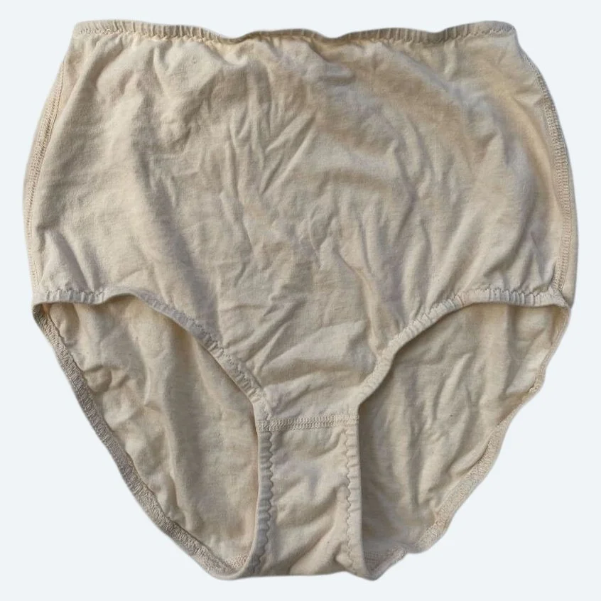 Flat lay of Pansy light xtra high rise underwear in natural on a pale blue-gray background.