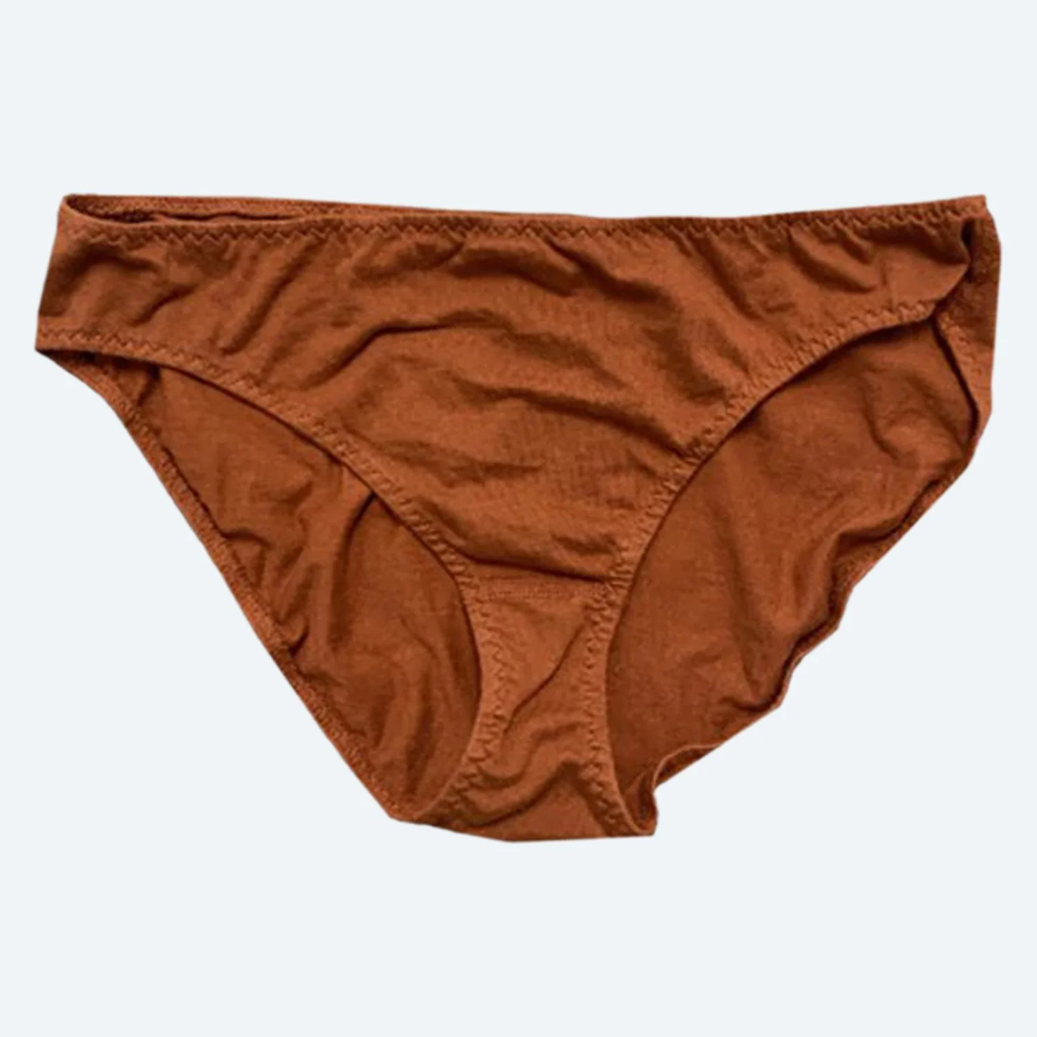 Front view of Pansy organic cotton Low Rise underwear in Rust, laid flat to show the low waistband and curved leg openings.