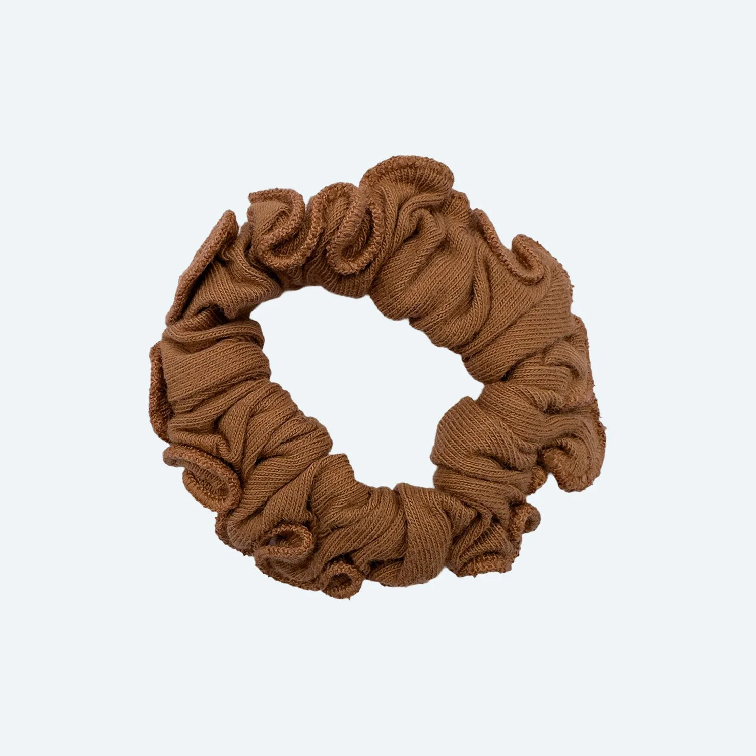 A Pansy organic cotton scrunchie in Almond brown, laid flat.