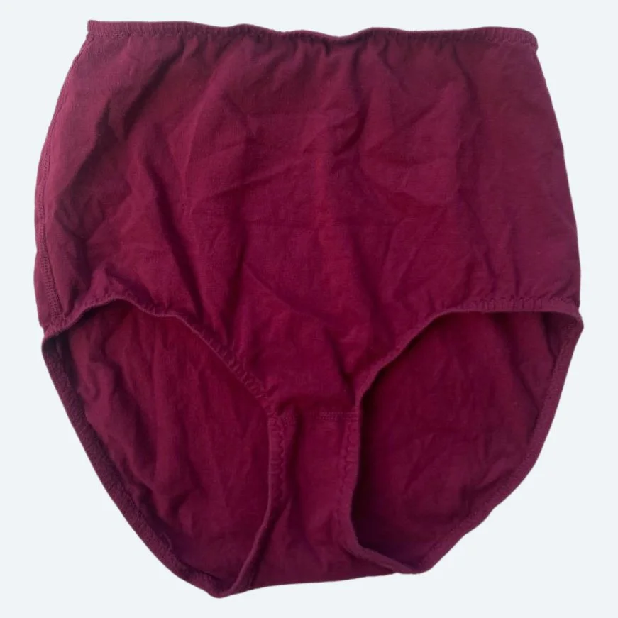 Flat lay of Pansy light xtra high rise underwear in wine on a pale blue-gray background.