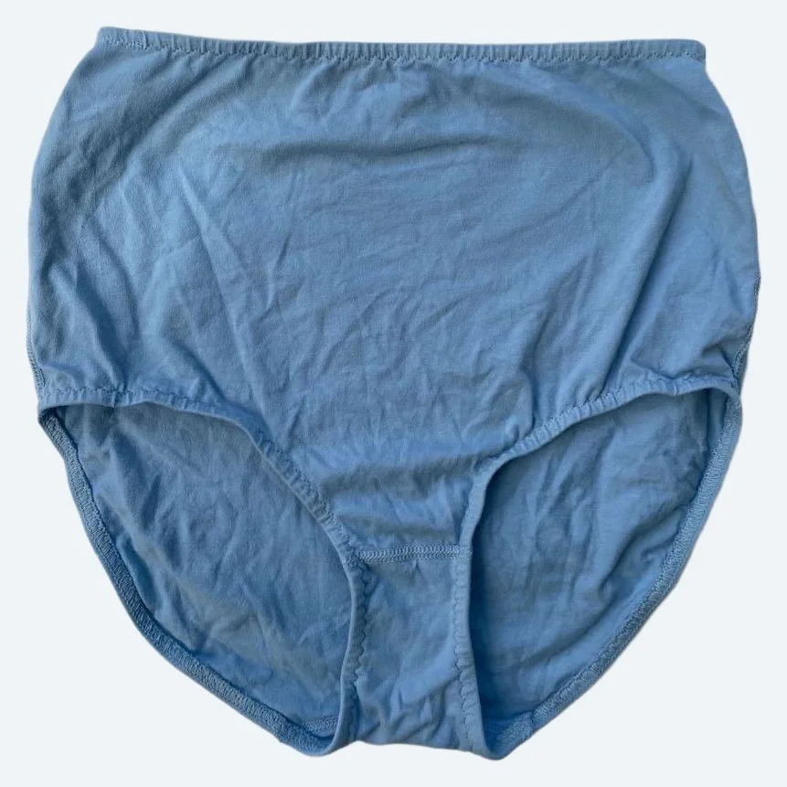 Flat lay of Pansy light xtra high rise underwear in sky blue on a pale blue-gray background.