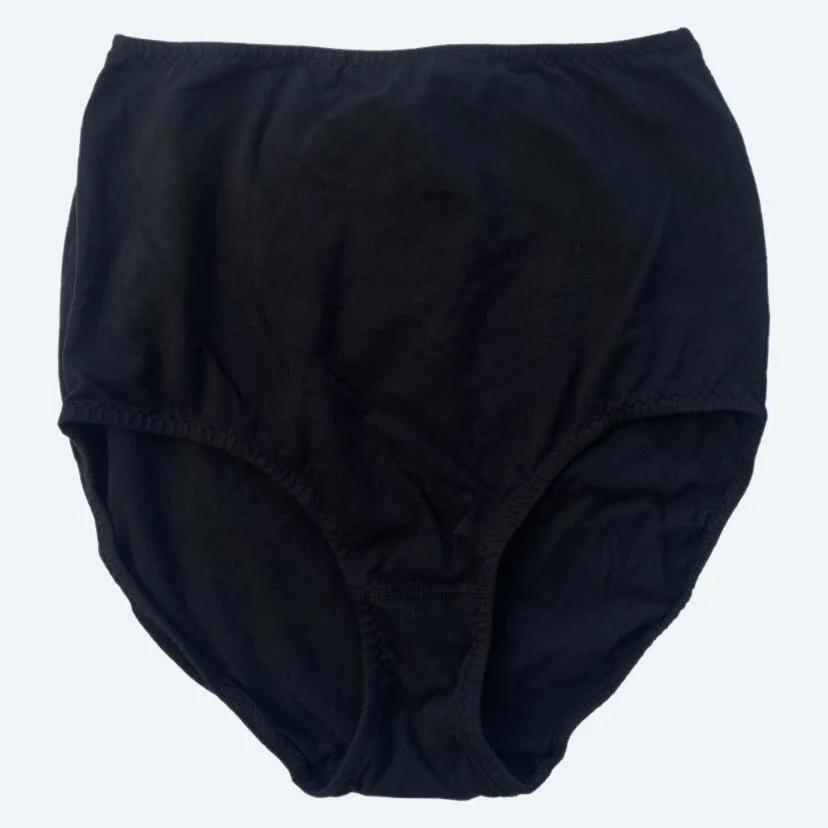 Flat lay of Pansy light xtra high rise underwear in black on a pale blue-gray background.