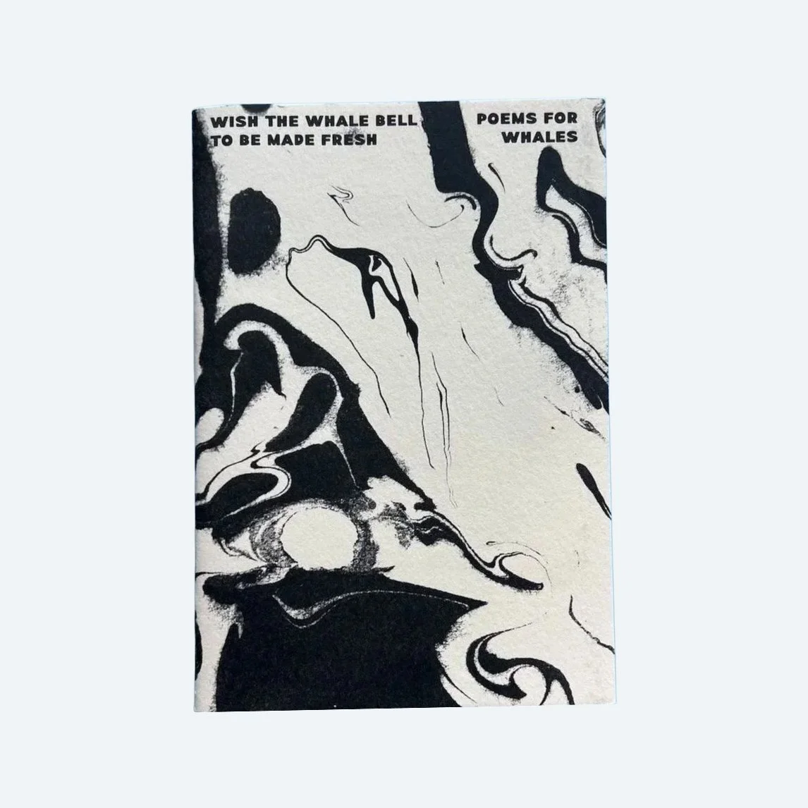Front cover of Wish the Whale Bell to be Made Fresh, with black Suminagashi marbling on cream cotton paper.