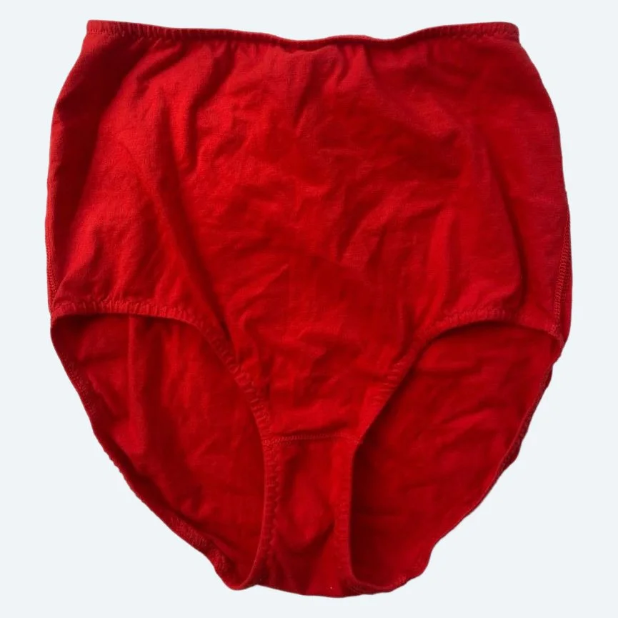Flat lay of Pansy light xtra high rise underwear in red on a pale blue-gray background.