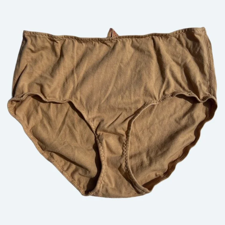Flat lay of Pansy high rise underwear in sand on a pale blue-gray background.